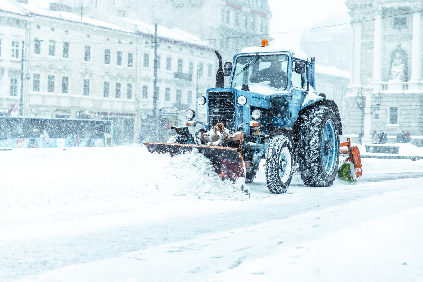 Snowplow clearing a commercial lot